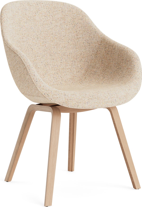 A front angle view of the AAC 123 About A Chair Upholstered Armchair with a wood base.